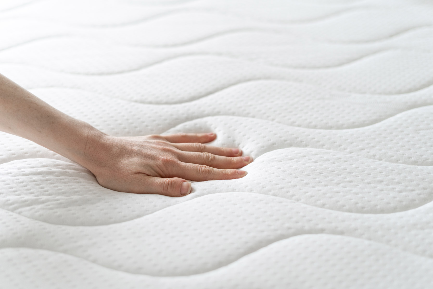 Woman Press On Comfortable Mattress And Checking Quality